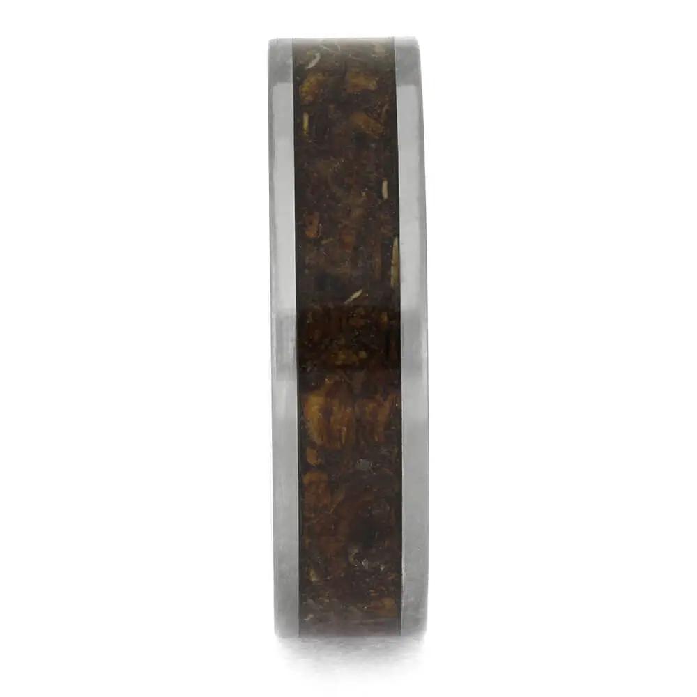 Wooden ring with a metallic band on a white background