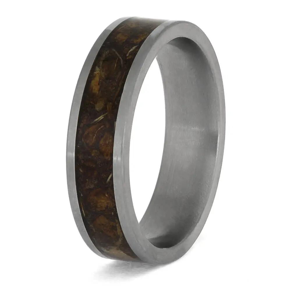 Ring with brown inlay and silver band on a white background