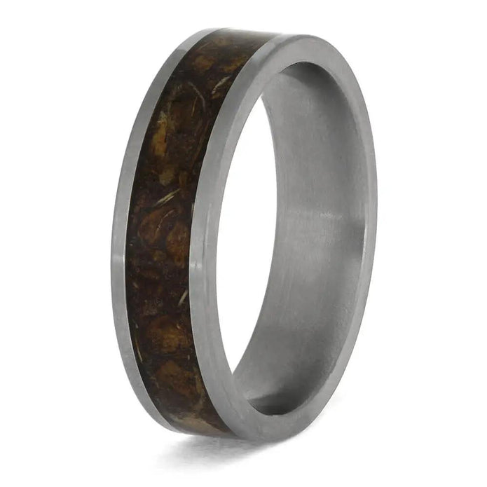 Ring with brown inlay and silver band on a white background