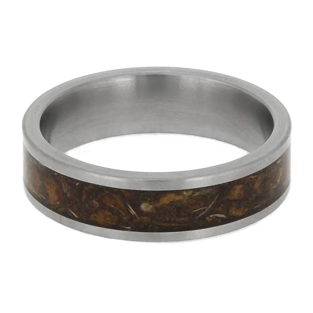Silver ring with a brown inlay on a white background