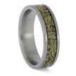Silver ring with embedded green material on a white background