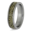 Silver ring with embedded green material on a white background