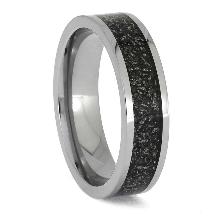 Silver ring with black textured interior on a white background