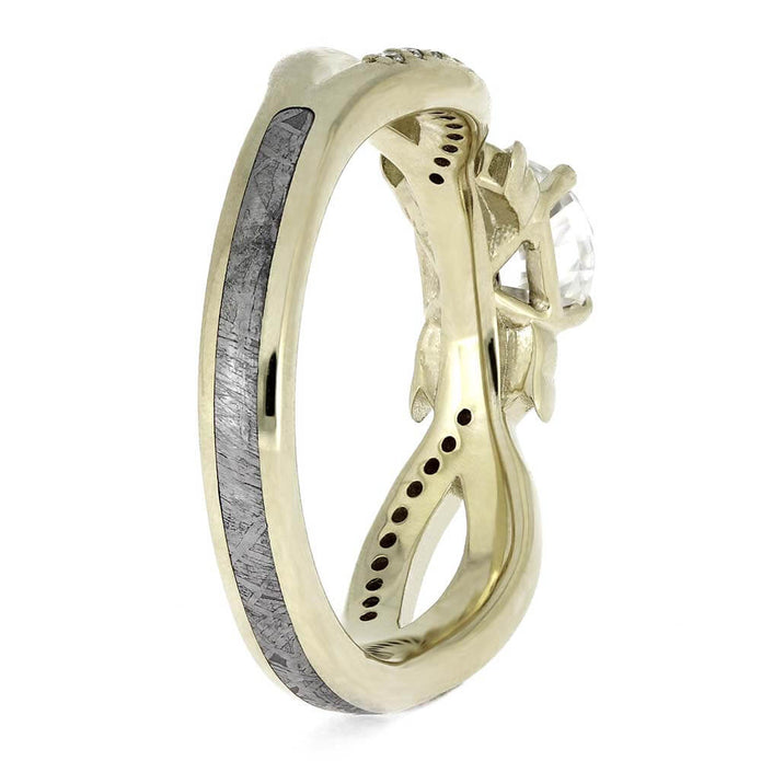 Gold ring with a unique design on a white background