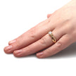 Hand wearing a gold ring with a diamond on a white background