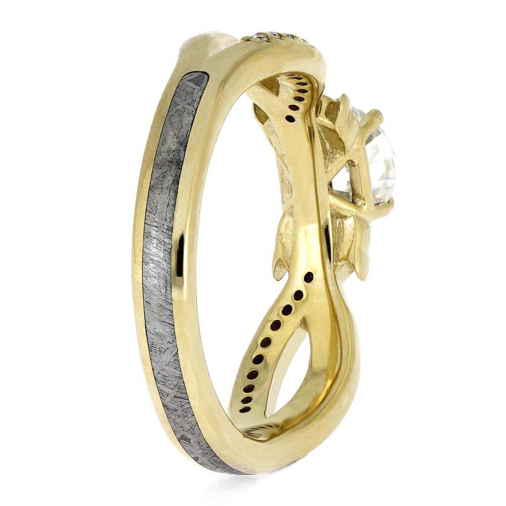 Gold ring with a white gemstone on a white background