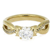 Gold ring with a large diamond and smaller diamonds on the band against a white background
