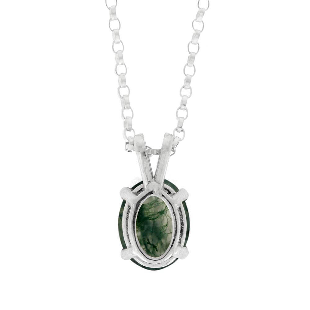 Silver necklace with a green stone pendant on a white background