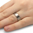 Silver ring on a person's finger against a white background