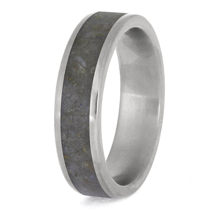 Silver ring with a textured band on a white background