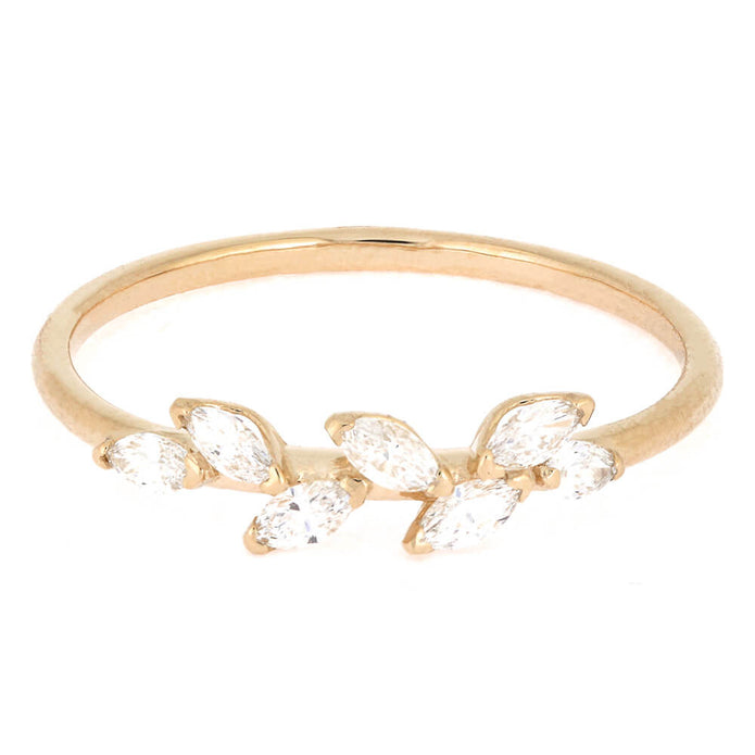 Gold ring with clear gemstones on a white background