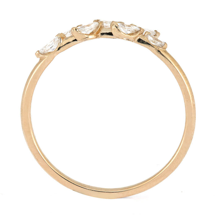 Gold ring with marquise-shaped gemstones on a white background