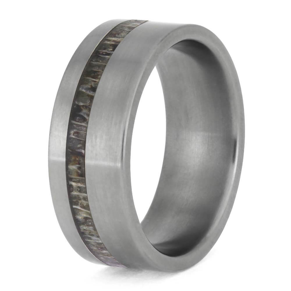 Silver ring with wooden inlay on a white background