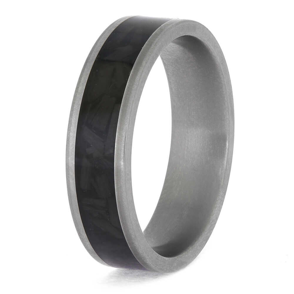 Silver ring with a black carbon fiber inlay on a white background