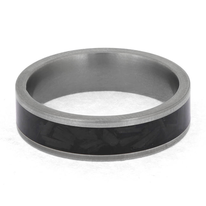 Silver ring with a black carbon fiber inlay on a white background