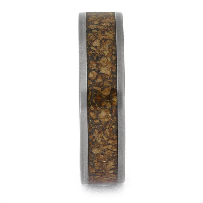 Wooden ring with a metallic band on a white background