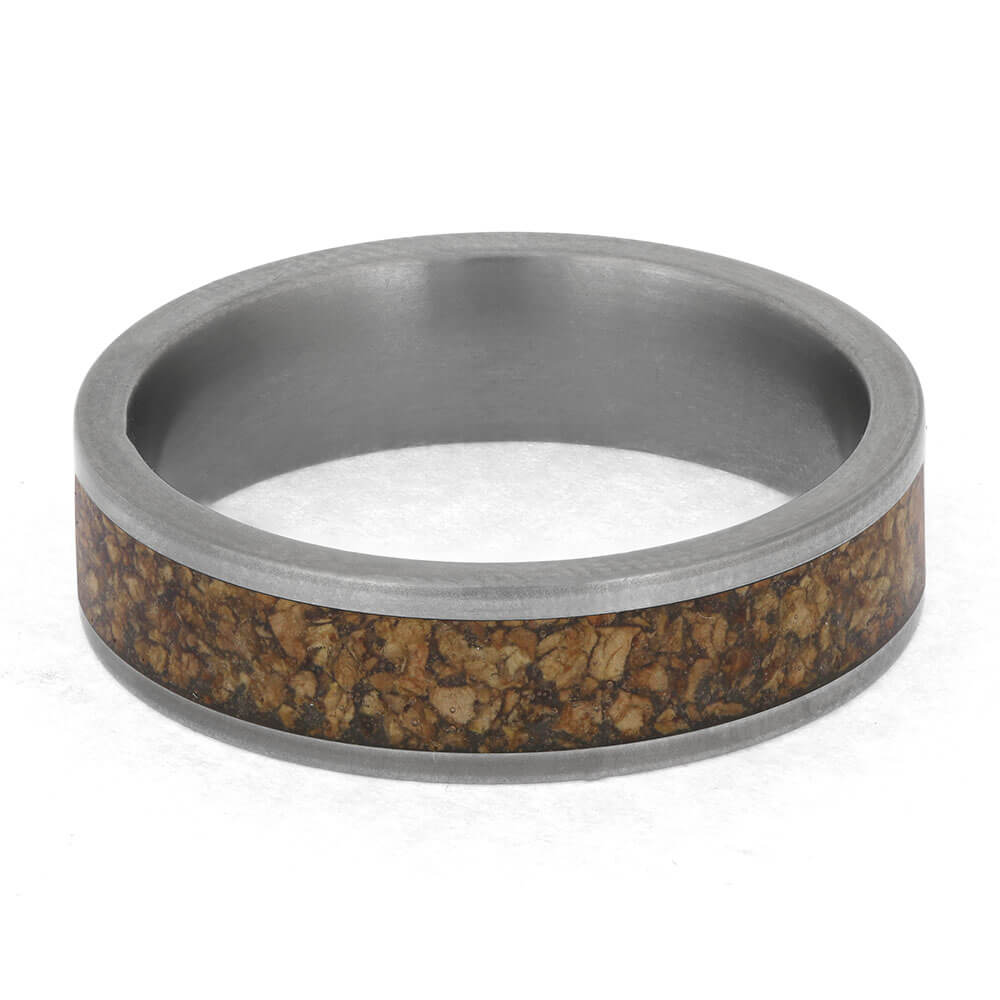 Ring with metallic band and cork inlay on a white background