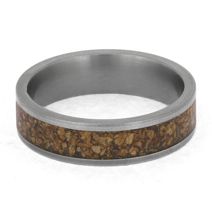 Ring with metallic band and cork inlay on a white background