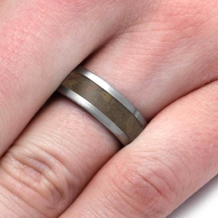 Close-up of a ring on a finger with a neutral background