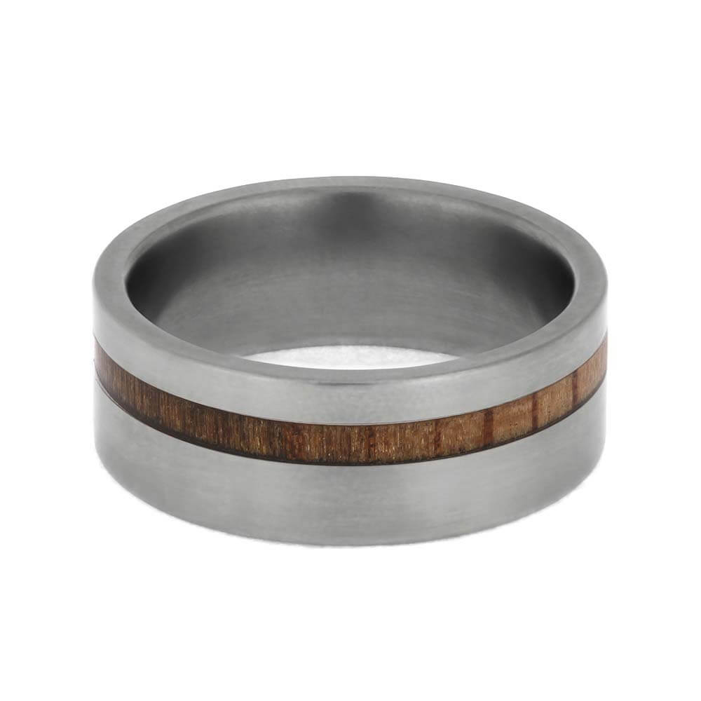 Silver ring with a wooden inlay on a white background
