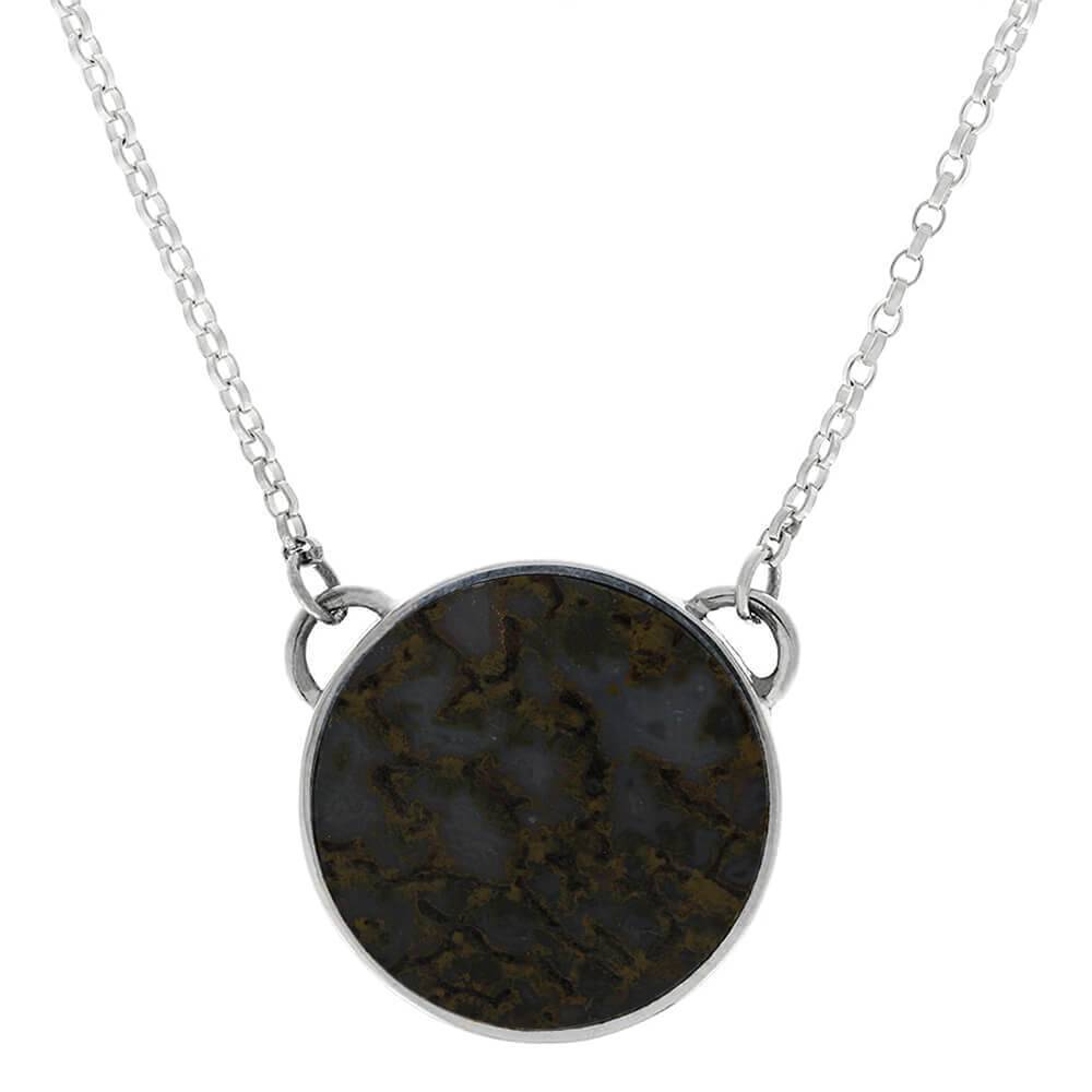 Navy blue dinosaur bone necklace in sterling silver bezel.