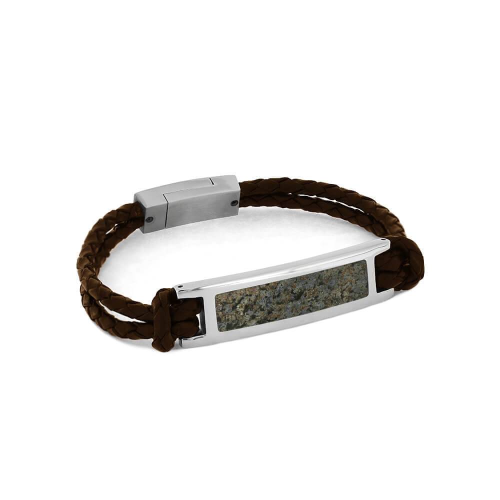 Speckled blue dinosaur bone bracelet with leather band.