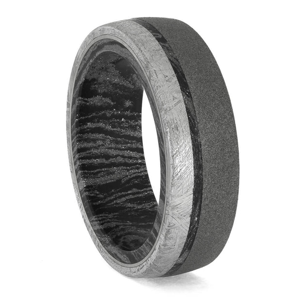 Two-tone ring with black and silver design on a white background