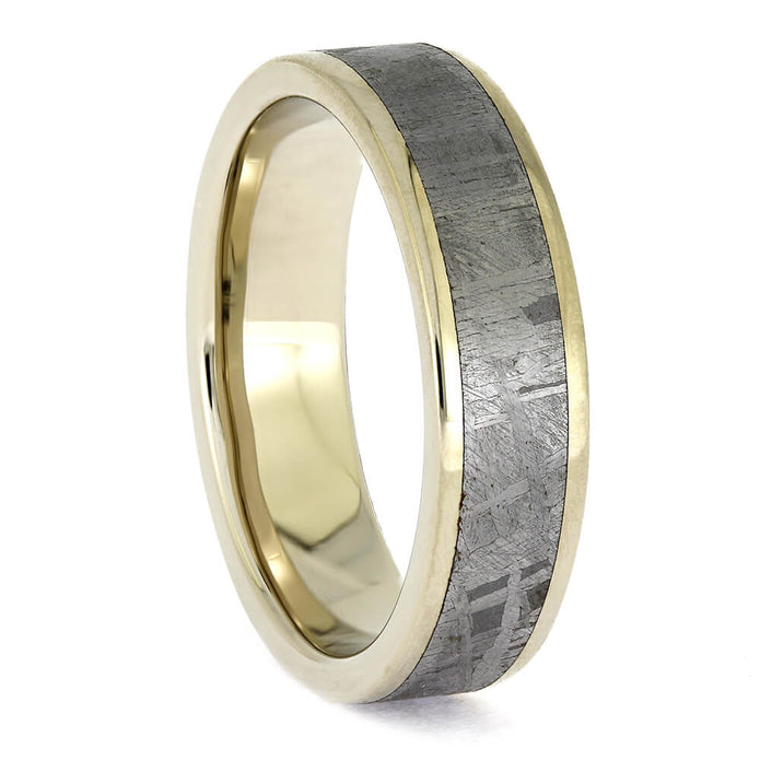 Gold ring with a textured gray interior on a white background