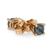 Gold earrings with blue gemstones on a white background