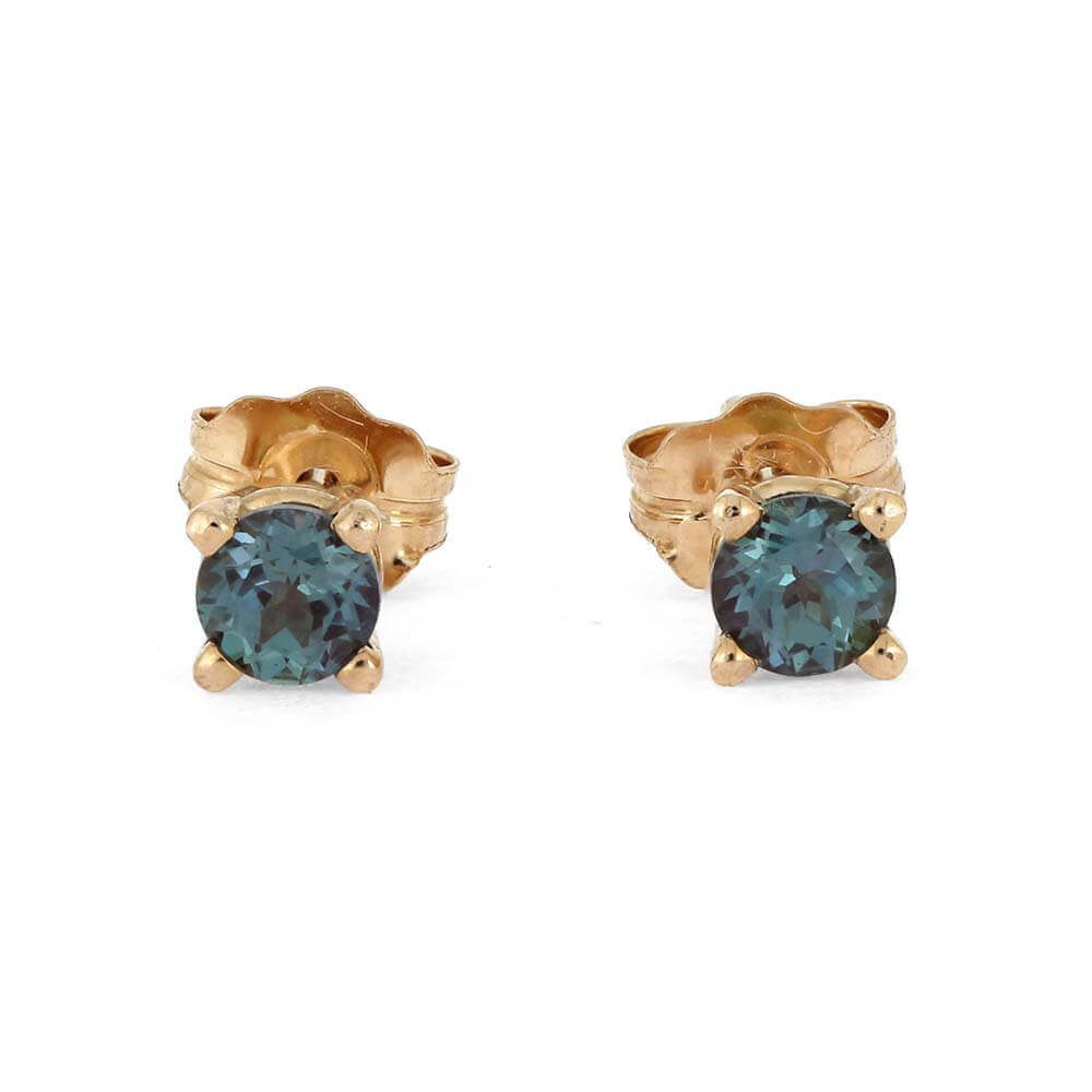 Gold stud earrings with blue gemstones on a white background