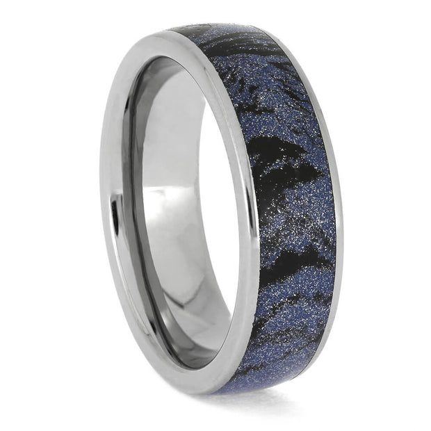 Silver ring with a blue and black patterned interior on a white background