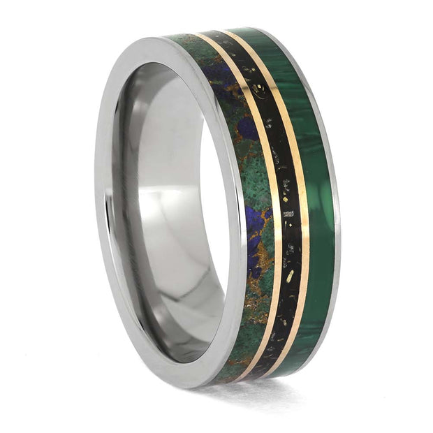 Ring with metallic and green inlay on a white background