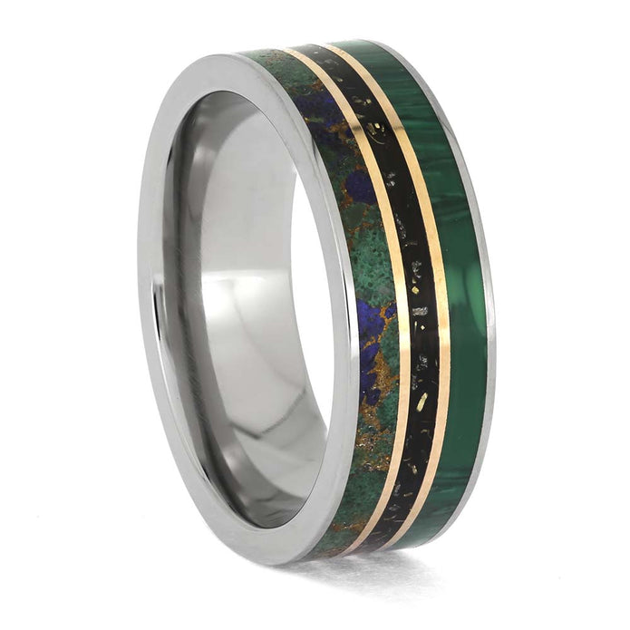 Ring with metallic and green inlay on a white background