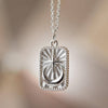 Silver medallion necklace with moon and starburst design