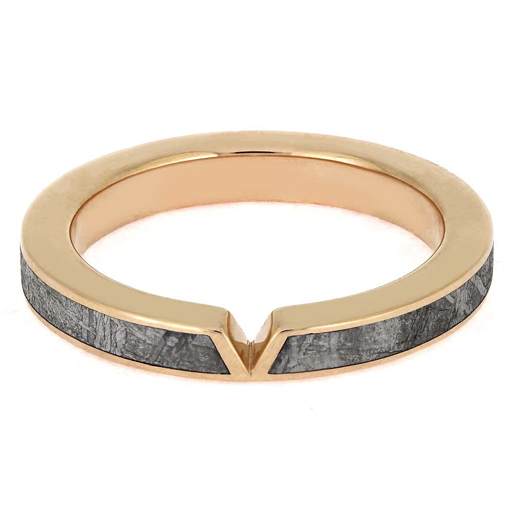 Gold ring with gray stone inlay on a white background