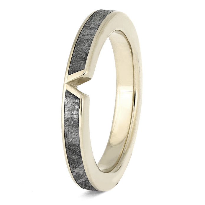 Gold ring with a textured black band on a white background