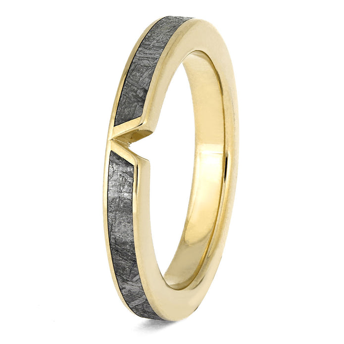 Gold ring with a textured black band on a white background