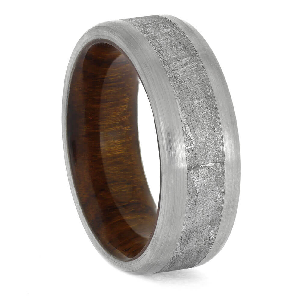Men's Meteorite Titanium Wedding Band with beveled brushed finish and rich ironwood sleeve, combining natural elements with modern design.