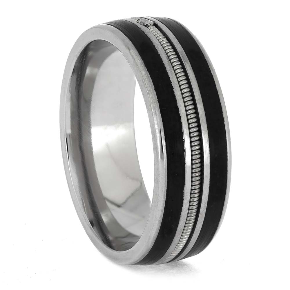 Silver ring with black inlay on a white background