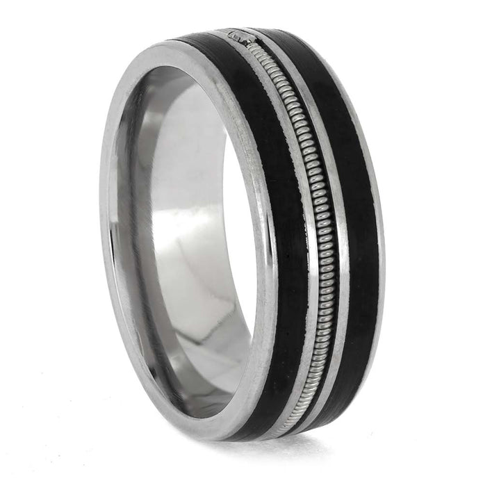 Silver ring with black inlay on a white background