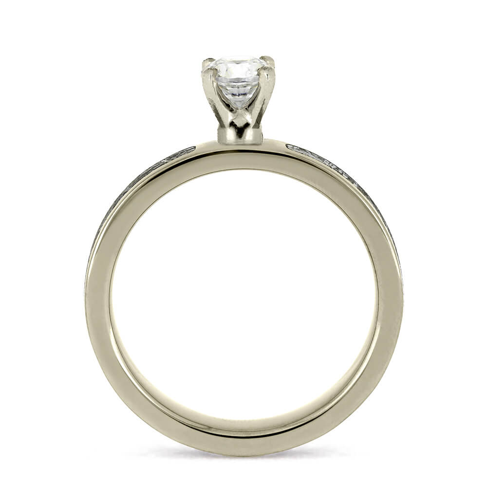 Minimalist design of a 0.5-carat diamond ring, shown from the side to highlight the prong setting and silver band.