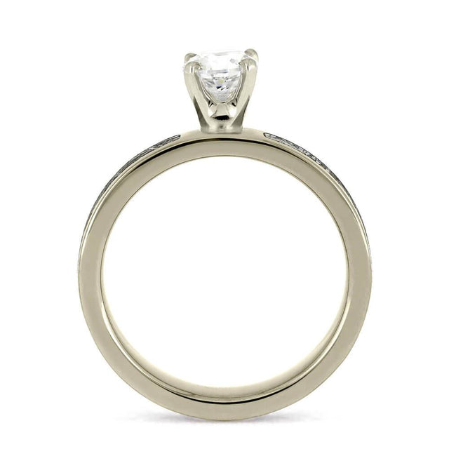 Minimalist design of a 0.5-carat diamond ring, shown from the side to highlight the prong setting and silver band.