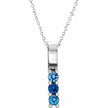 Silver necklace with blue gemstones on a white background