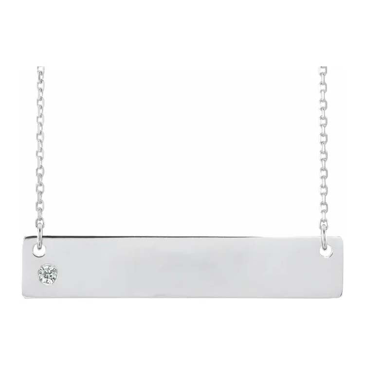 Silver necklace with a bar pendant and small round gemstone on a white background