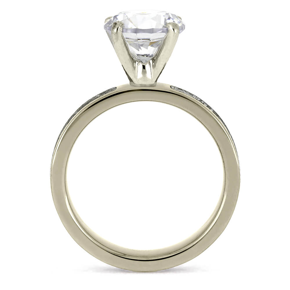 Side view of a 3.0-carat diamond ring, showcasing the diamond in a prong setting on a silver band