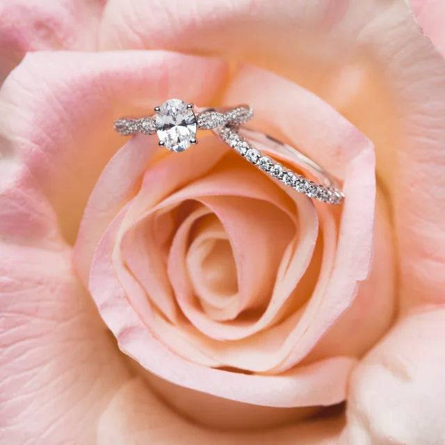 Diamond anniversary band paired with engagement ring on rose