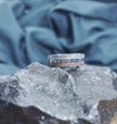 Unique meteorite ring on textured rock background