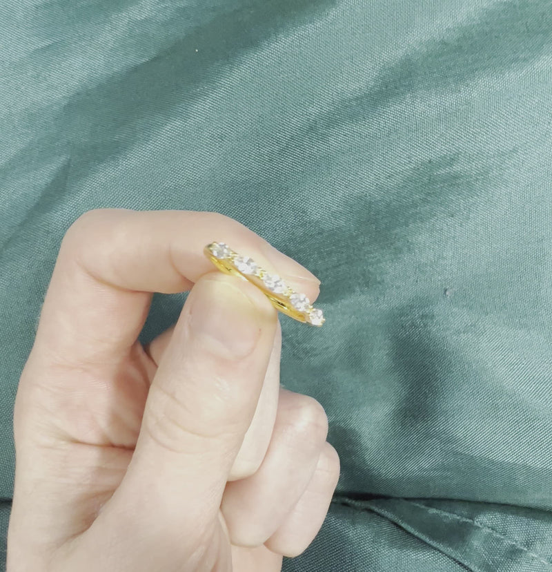 Hand holding marquise cut diamond wedding band