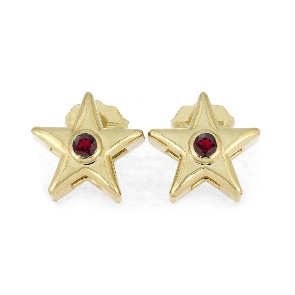 Gold star stud earrings with red birthstone on white background