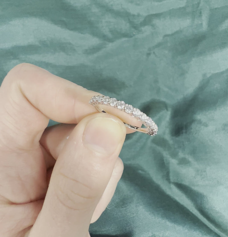 Hand holding 1/2 CTW diamond anniversary band